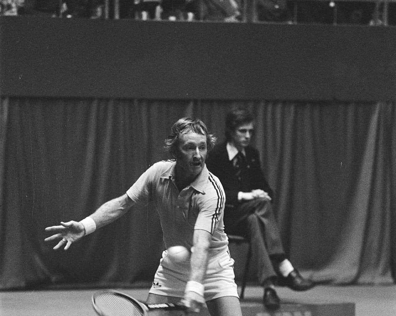 Rod Laver stretching for a forehand on an indoor court in Rotterdam in the 1970s